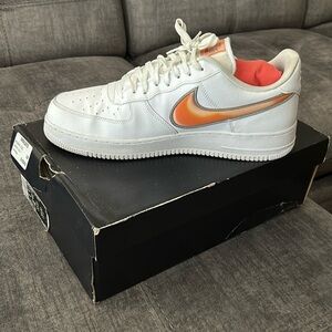 Nike Air Force 1’s with orange swoosh